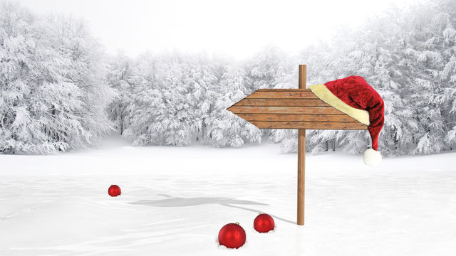 Wooden sign with Santa hat on snowy field