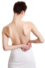 Young man with hands on his back