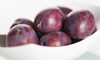 Close up of plums on plate.