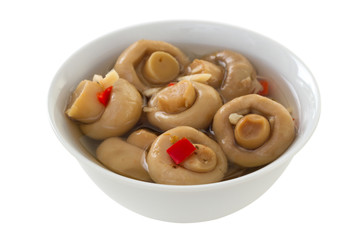 marinated mushrooms with pepper in white bowl