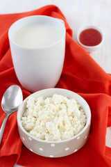 cottage cheese in the bowl and cup of milk