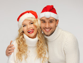 family couple in sweaters and santa's hats
