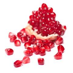 Ripe pomegranate piece isolated on white background