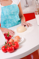Obraz na płótnie Canvas Woman hands mixing dough on the table