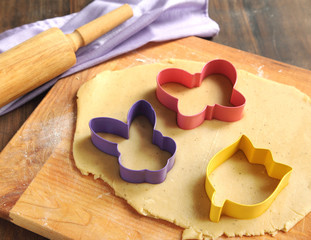 Baking background with dough and Easter cookie cutters