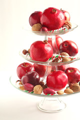 Apples, pomegranates, nuts and candy canes in a vase