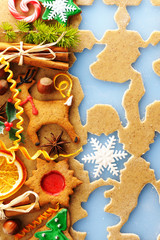 Christmas spices and cookies over gingerbread dough