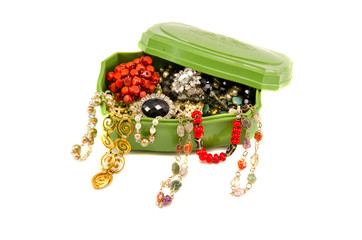 retro box with assorted vintage necklaces on white