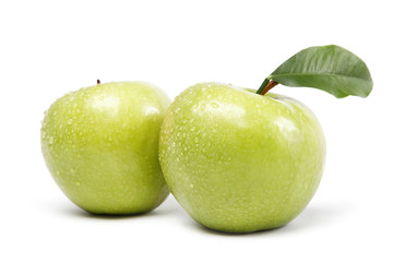 Two green apple in drops of water on a white background.