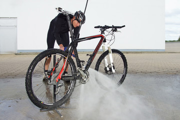 man washing the bike