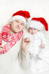 Christmas family  in red hats. father and baby