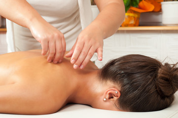 Fototapeta na wymiar Beautiful young women getting a massage in massage salon