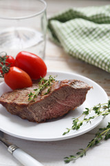 Beef steak with green salad and tomatoes