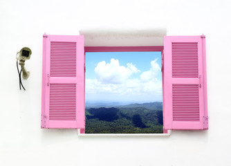 Greek style window and cctv with mountain and sky view
