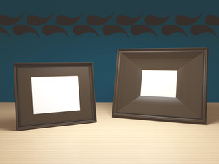 Brown photo frames on wooden table.