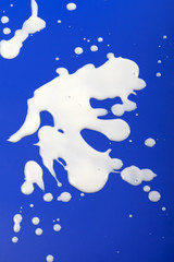 Stains from milk on blue background
