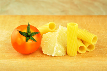 Raw tortiglioni pasta with parmesan and cherry tomato