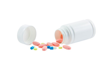 Spilled container of medicines isolated on white