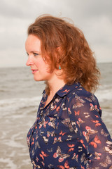 Pretty young woman enjoying outdoor nature near the beach.