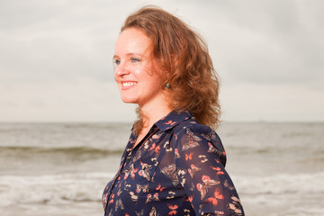 Pretty young woman enjoying outdoor nature near the beach.