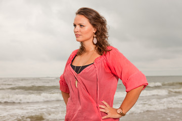 Pretty young woman enjoying outdoor nature near the beach.