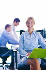 business woman with her staff in background at office