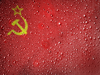 The USSR flag painted on metal surface covered with rain drops