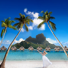 bride on a beach with palm and mountain. Bora-Bora. Polynesia - obrazy, fototapety, plakaty