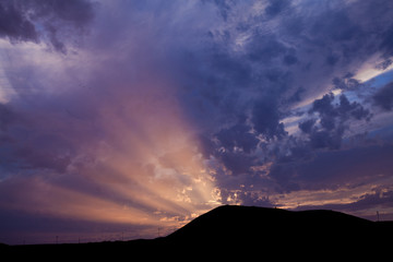 sunset over volcanic landscape