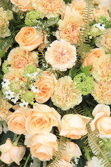 Carnations and roses in pale orange