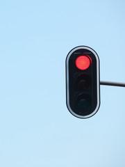 Red traffic lights against blue sky backgrounds