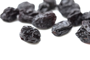 black raisins on a white background