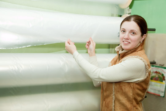 Woman  chooses polythene at foil roll