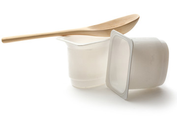 Empty plastic yoghurt pots with spoon