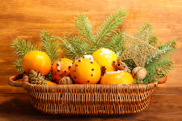 christmas composition in basket with oranges and fir tree,