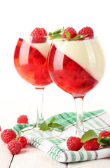 fruit jelly with berries in glasses on wooden table