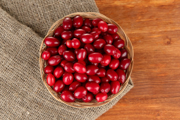 fresh cornel berries in wicker basket