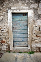 Fototapeta na wymiar Blue door in old stone house