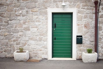 Fototapeta na wymiar Green door in old stone house