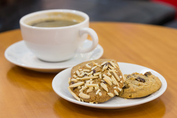 Black coffee with cookies on table