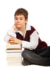 Schoolboy with stack of books