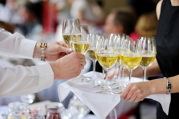Waitress with dish of champagne glasses