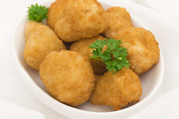 Breaded deep fried mushrooms garnished with parsley