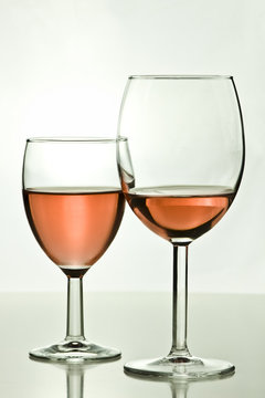 two  wine glasses on a table