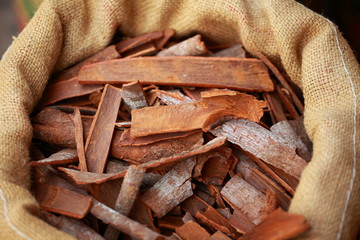 Big bag with cinnamon sticks in indian market