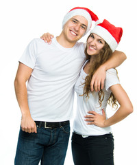 Beautiful Christmas couple in Santa hats