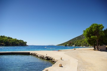 Concrete empty beach in the bay of turquoise sea, Croatia