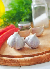 Fresh garlic and aroma spice on the wooden board