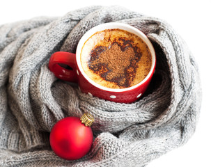 Cup of cocoa wrapped in grey scarf
