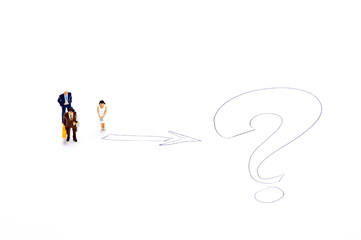 Miniature people on white with some diagrams